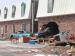 Katrina Pics - A car thrown through a brick wall, see the chair in the windsheild?